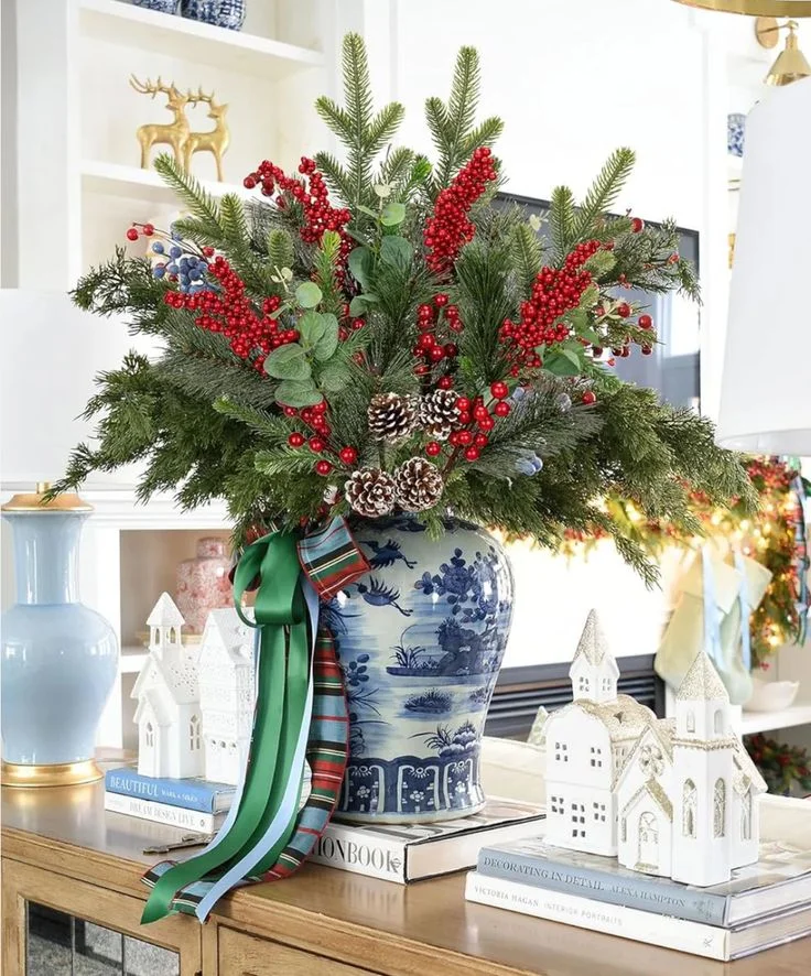 A pine arrangement in a vase on a dresser top